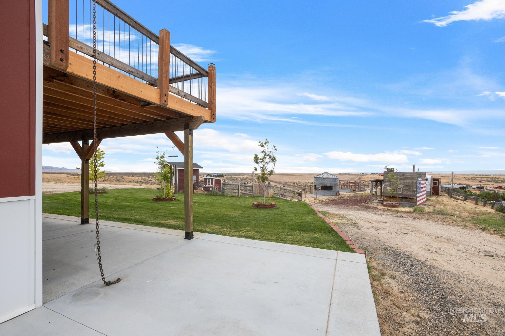 870 Desert Wind Road Boise, ID 83716 - Photo 43 of 50 Elevated red-sided structure with a metal roof and a surrounding wooden deck