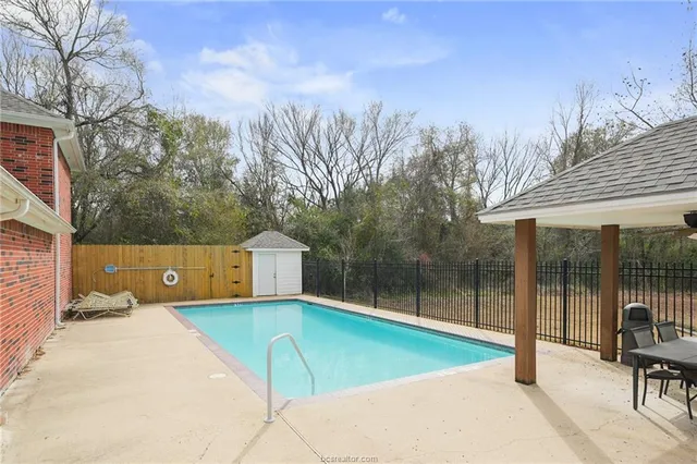 a view of a swimming pool with a lounge chair