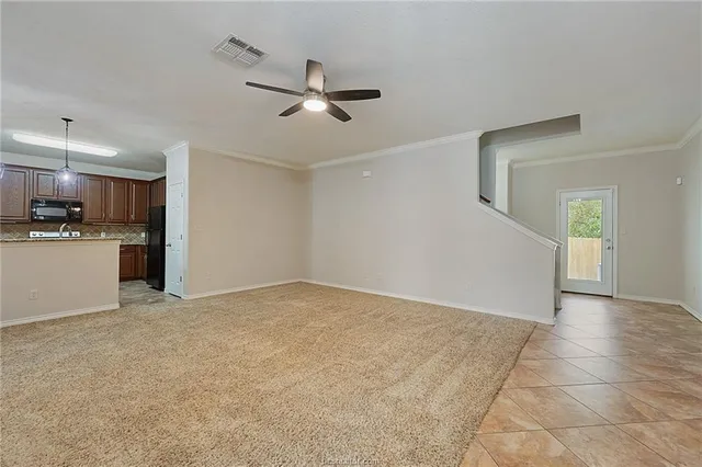 a view of a kitchen with a sink and a refrigerator