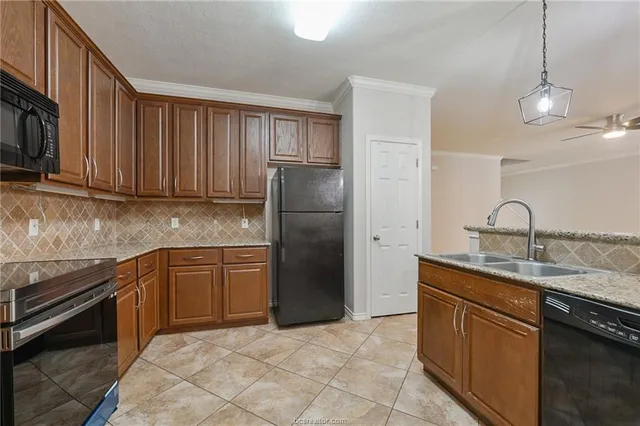 a kitchen with stainless steel appliances granite countertop a refrigerator and a sink