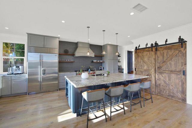 a living room with lots of furniture and a chandelier