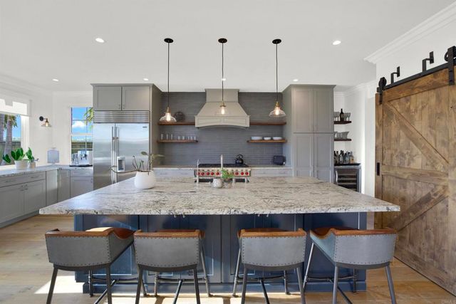a dining room with furniture a chandelier and wooden floor
