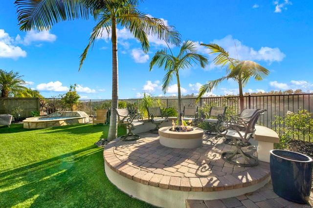 a view of a swimming pool with a patio and a garden