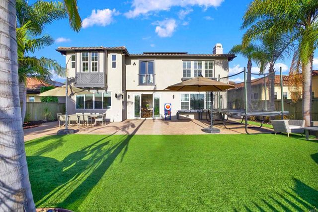 a view of a hallway with seating space and a chandelier