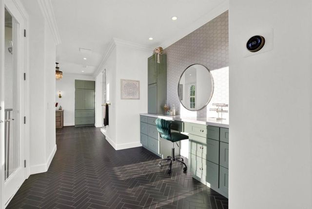 a bedroom with a large bed chandelier and a window