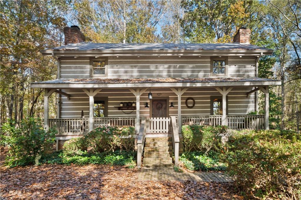 4131 Sandy Creek Road Madison, GA 30650 - Photo 1 of 1 a front view of a house with a yard