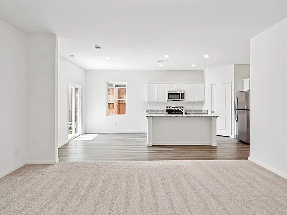 152 Mullen Way Taylor, TX 76574 - Photo 9 of 21 a view of kitchen with granite countertop cabinets and refrigerator