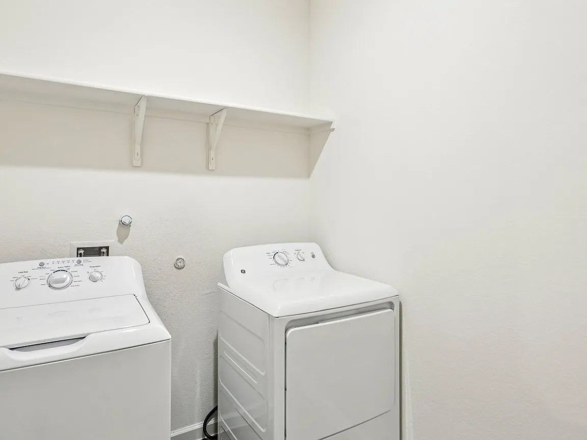 152 Mullen Way Taylor, TX 76574 - Photo 11 of 21 a utility room with dryer and washer