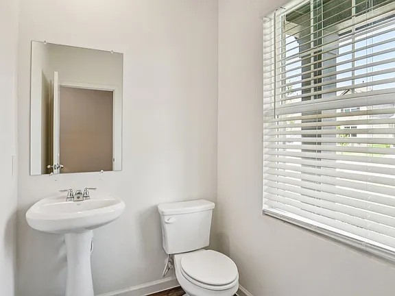 152 Mullen Way Taylor, TX 76574 - Photo 12 of 21 a bathroom with a sink a mirror and a toilet
