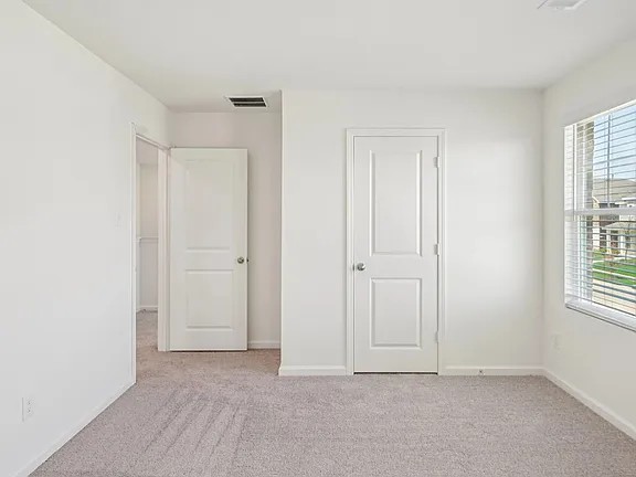 152 Mullen Way Taylor, TX 76574 - Photo 15 of 21 an empty room with windows and closet
