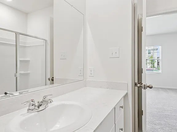 152 Mullen Way Taylor, TX 76574 - Photo 17 of 21 a bathroom with a sink and a mirror