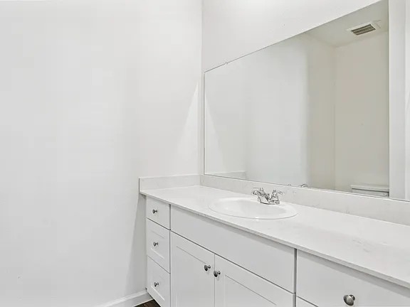 152 Mullen Way Taylor, TX 76574 - Photo 18 of 21 a bathroom with a sink and a mirror