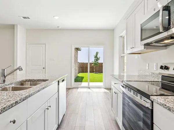 a kitchen with a sink stove and microwave