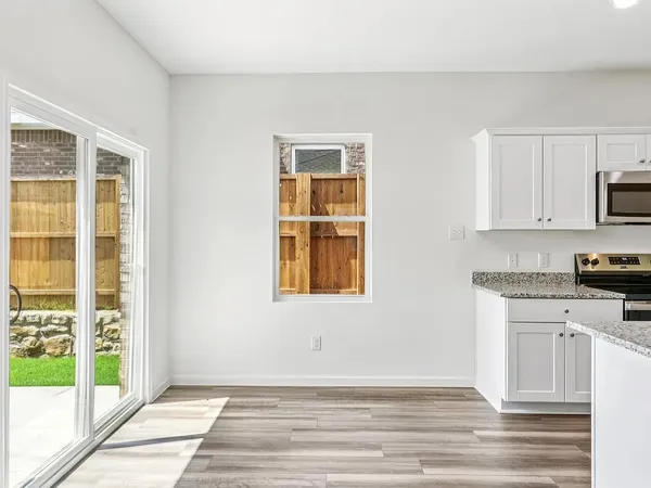 a kitchen with stainless steel appliances granite countertop a refrigerator stove and sink