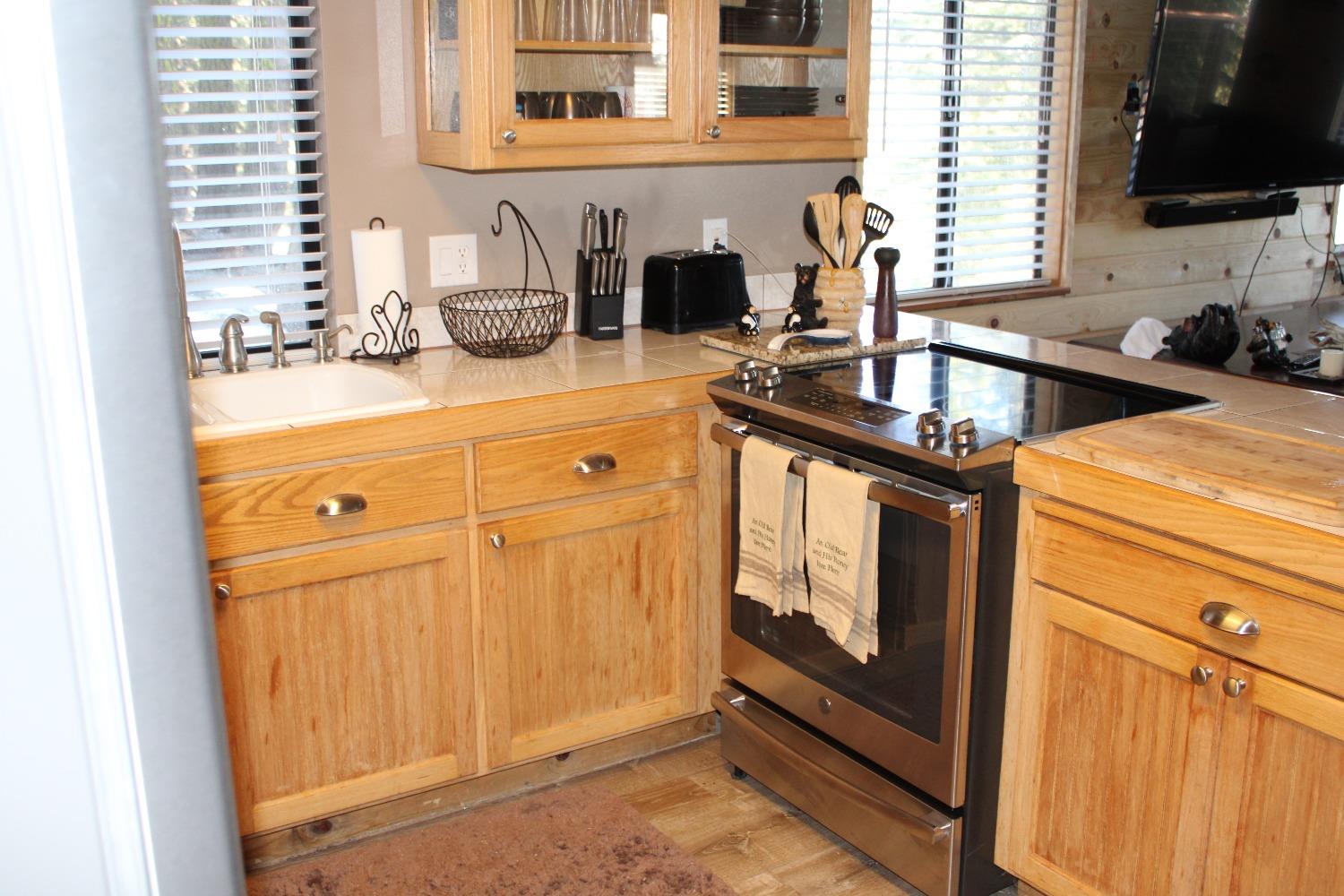 1140 Mountain View Road Arnold, CA 95223 - Photo 11 of 24 a kitchen with a sink and cabinets