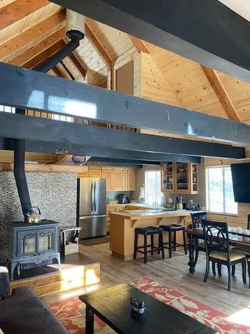a kitchen with stainless steel appliances kitchen island granite countertop a table and chairs in it