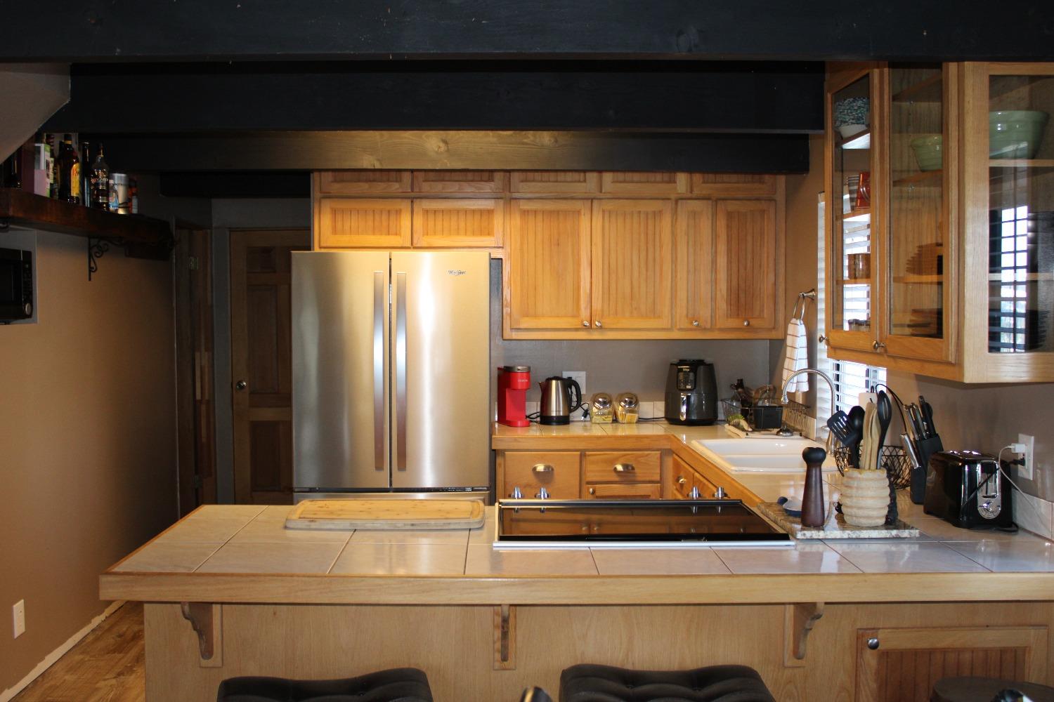 1140 Mountain View Road Arnold, CA 95223 - Photo 10 of 24 a kitchen with a refrigerator and a sink