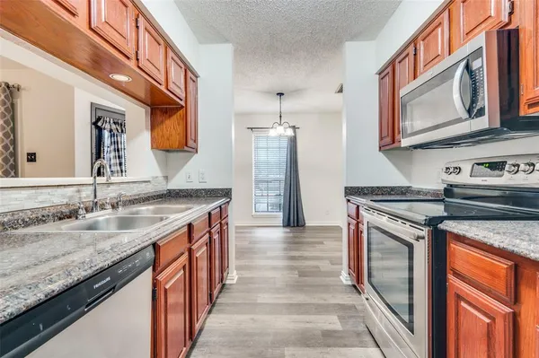a kitchen with stainless steel appliances granite countertop a stove and a sink