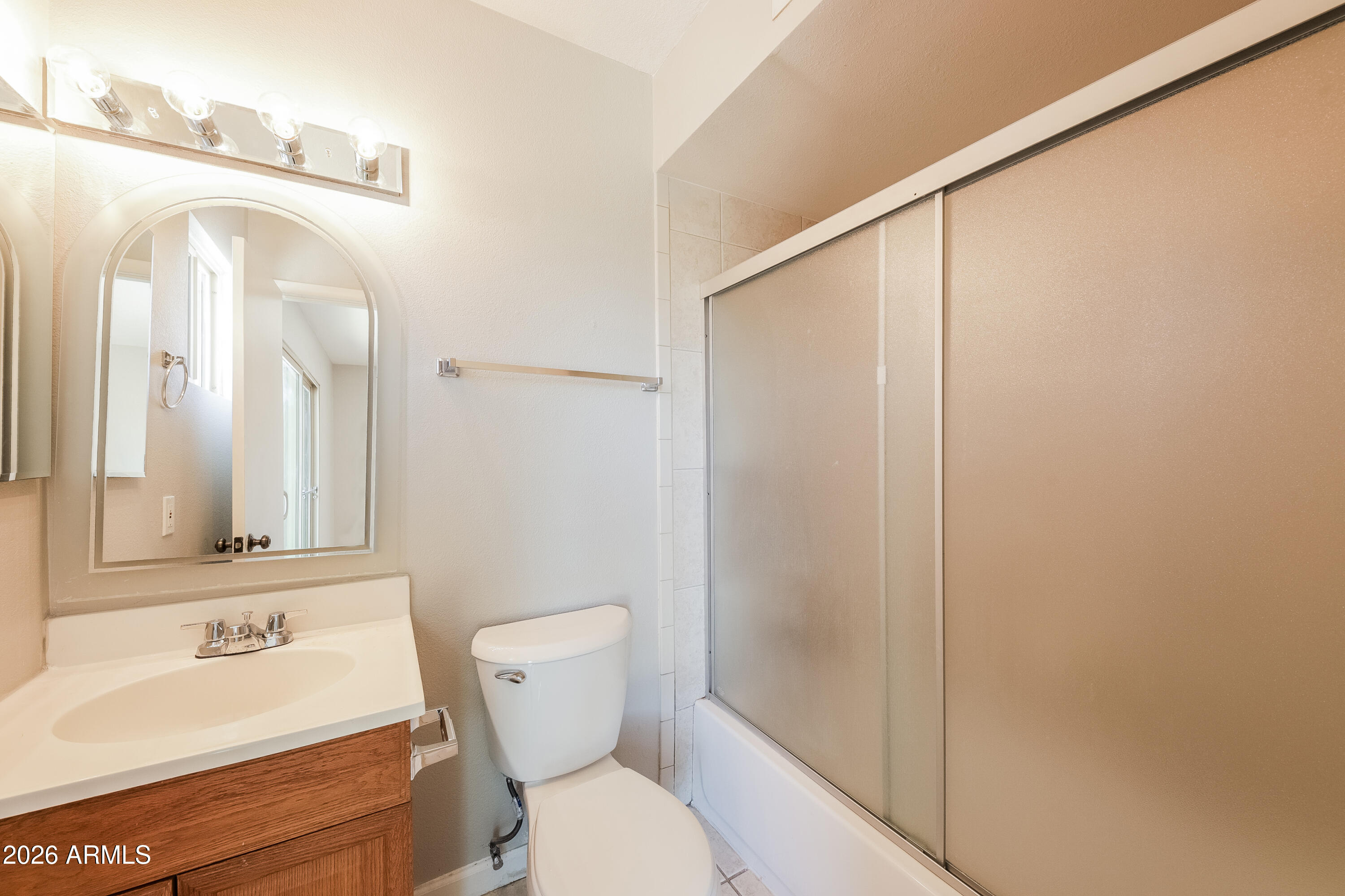 2501 East Villa Rita Drive Phoenix, AZ 85032 - Photo 13 of 15 a bathroom with a toilet a sink and a mirror