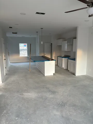 a view of a kitchen with a sink and cabinets