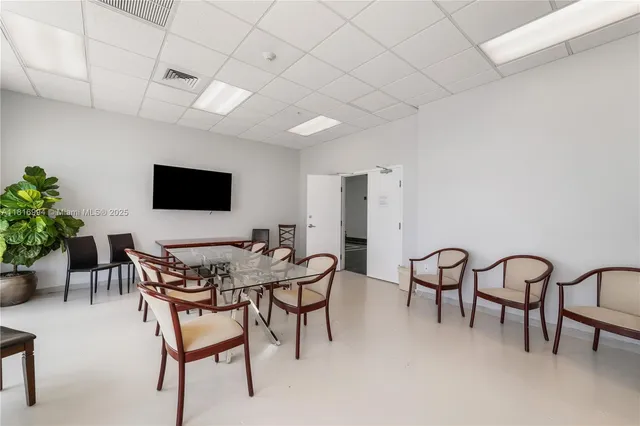 a view of a livingroom with furniture and a flat screen tv
