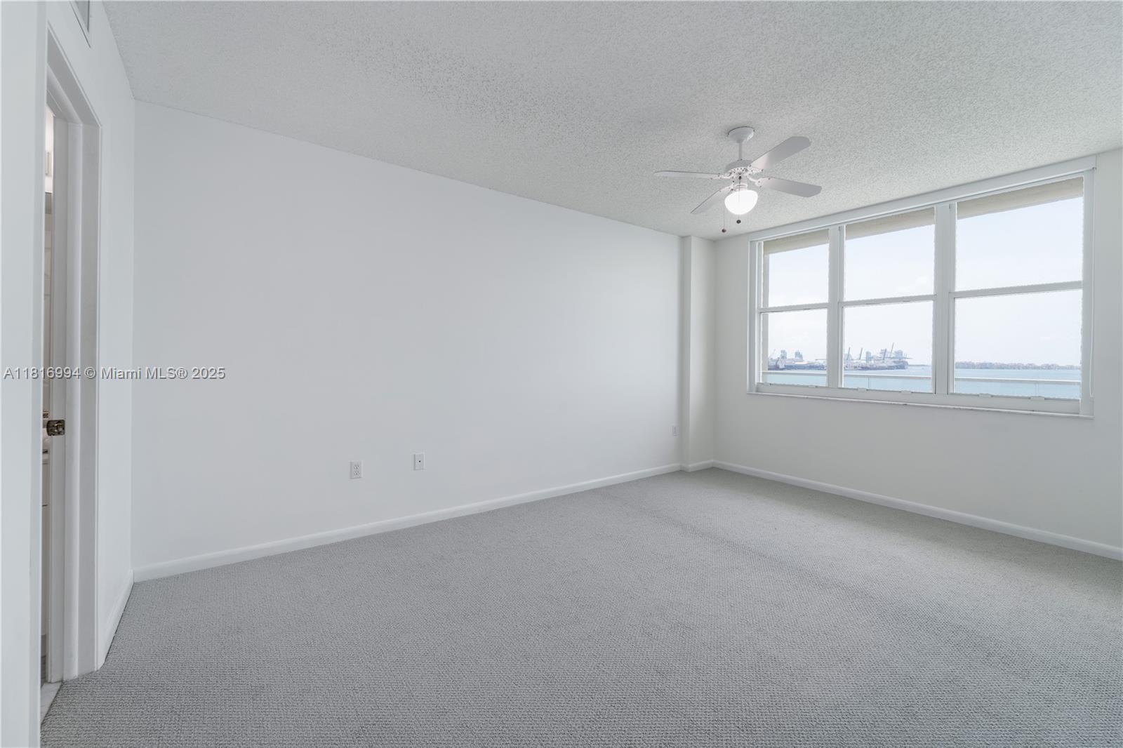 800 Claughton Island Drive, Unit 1103 Miami, FL 33131 - Photo 22 of 40 an empty room with a empty space and windows