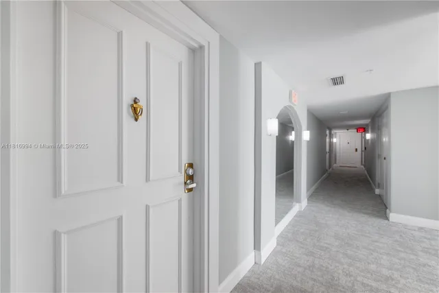 a bathroom with a glass shower door and a mirror
