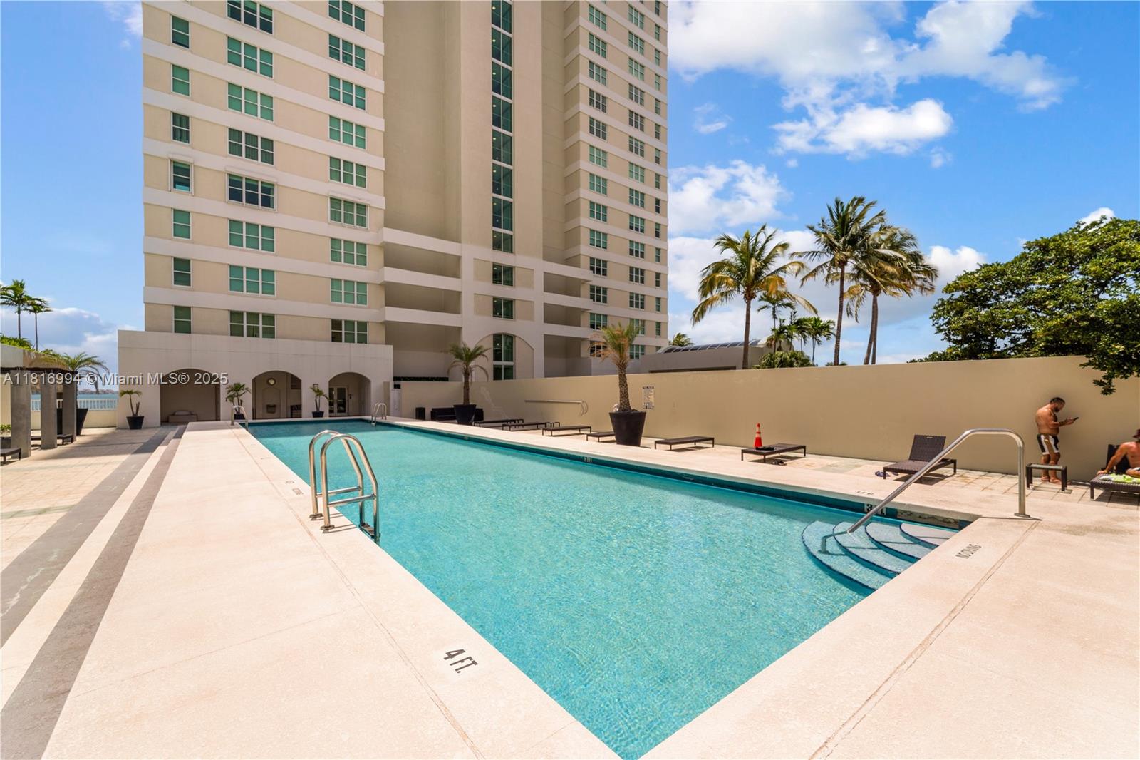800 Claughton Island Drive, Unit 1103 Miami, FL 33131 - Photo 36 of 40 a view of swimming pool from a lounge chair in front of house