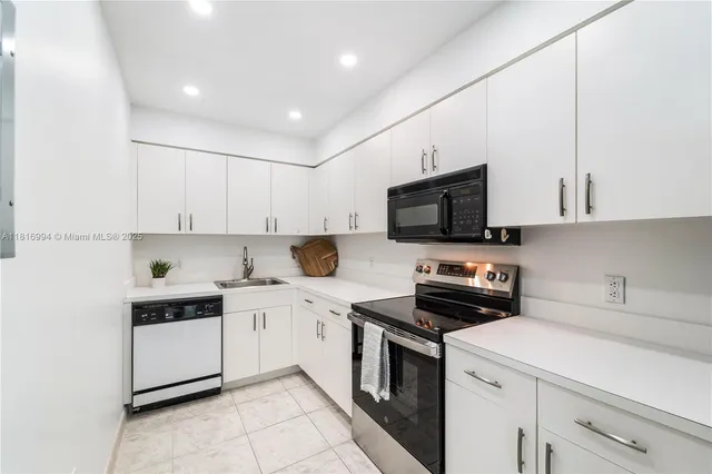 a kitchen with a sink a stove and cabinets
