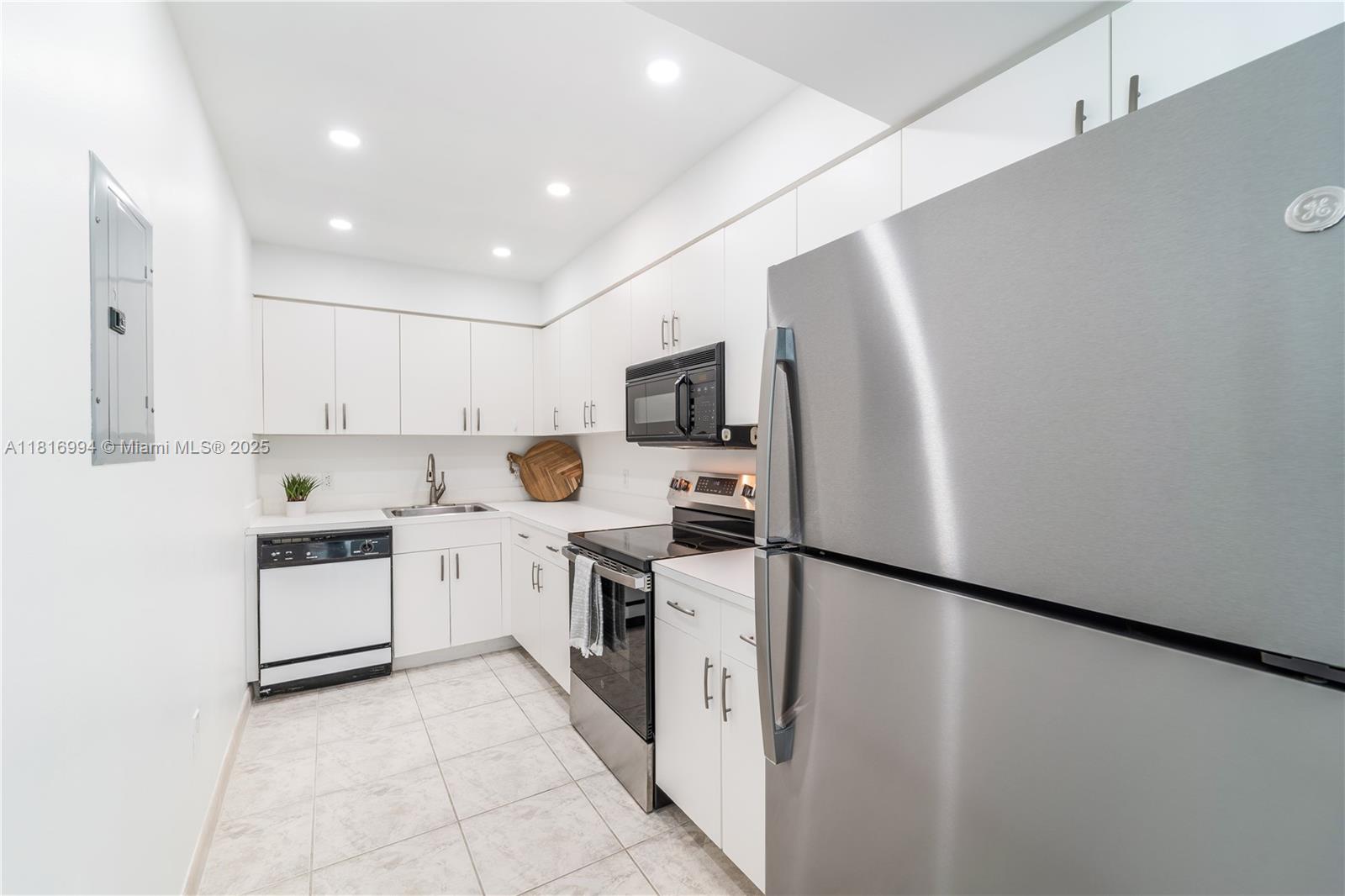 800 Claughton Island Drive, Unit 1103 Miami, FL 33131 - Photo 6 of 40 a kitchen with stainless steel appliances granite countertop a refrigerator a stove top oven a sink and dishwasher