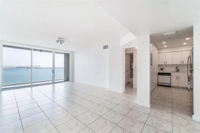 a view of a electric appliances and windows in a room