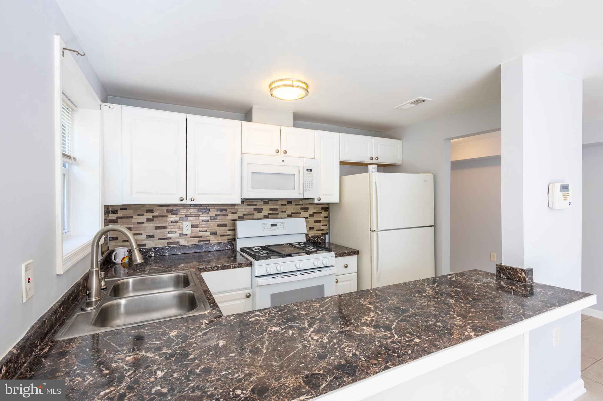 314 Atlantic Street Southeast, Unit 1 Washington, DC 20032 - Photo 11 of 17 a kitchen with a refrigerator and a sink