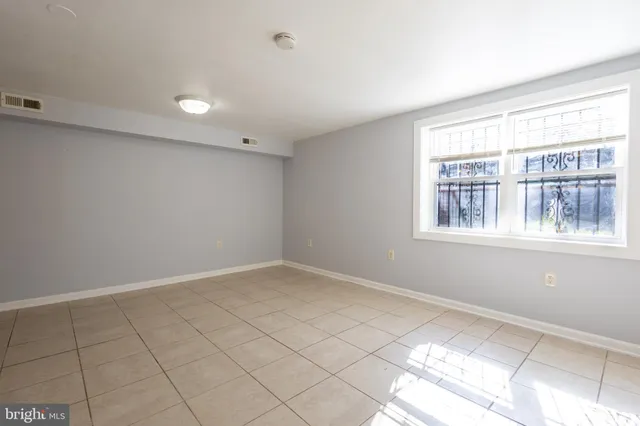 a view of an empty room and a window