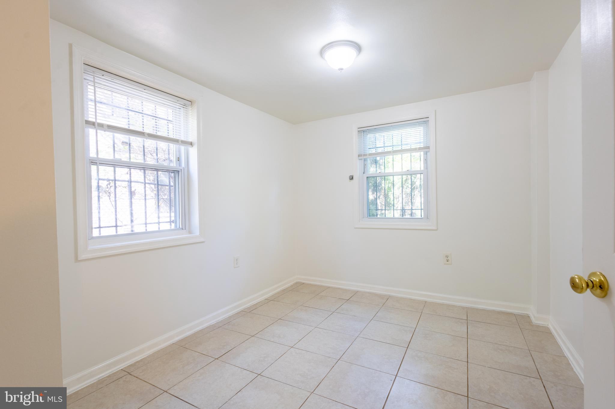 314 Atlantic Street Southeast, Unit 1 Washington, DC 20032 - Photo 3 of 17 an empty room with windows