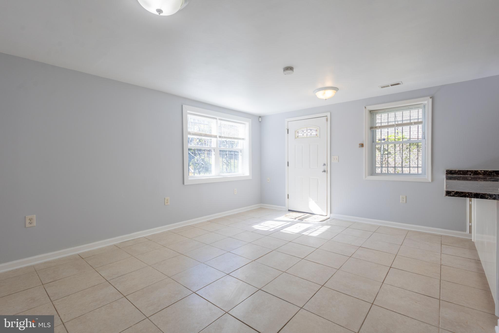 314 Atlantic Street Southeast, Unit 1 Washington, DC 20032 - Photo 4 of 17 an empty room with windows