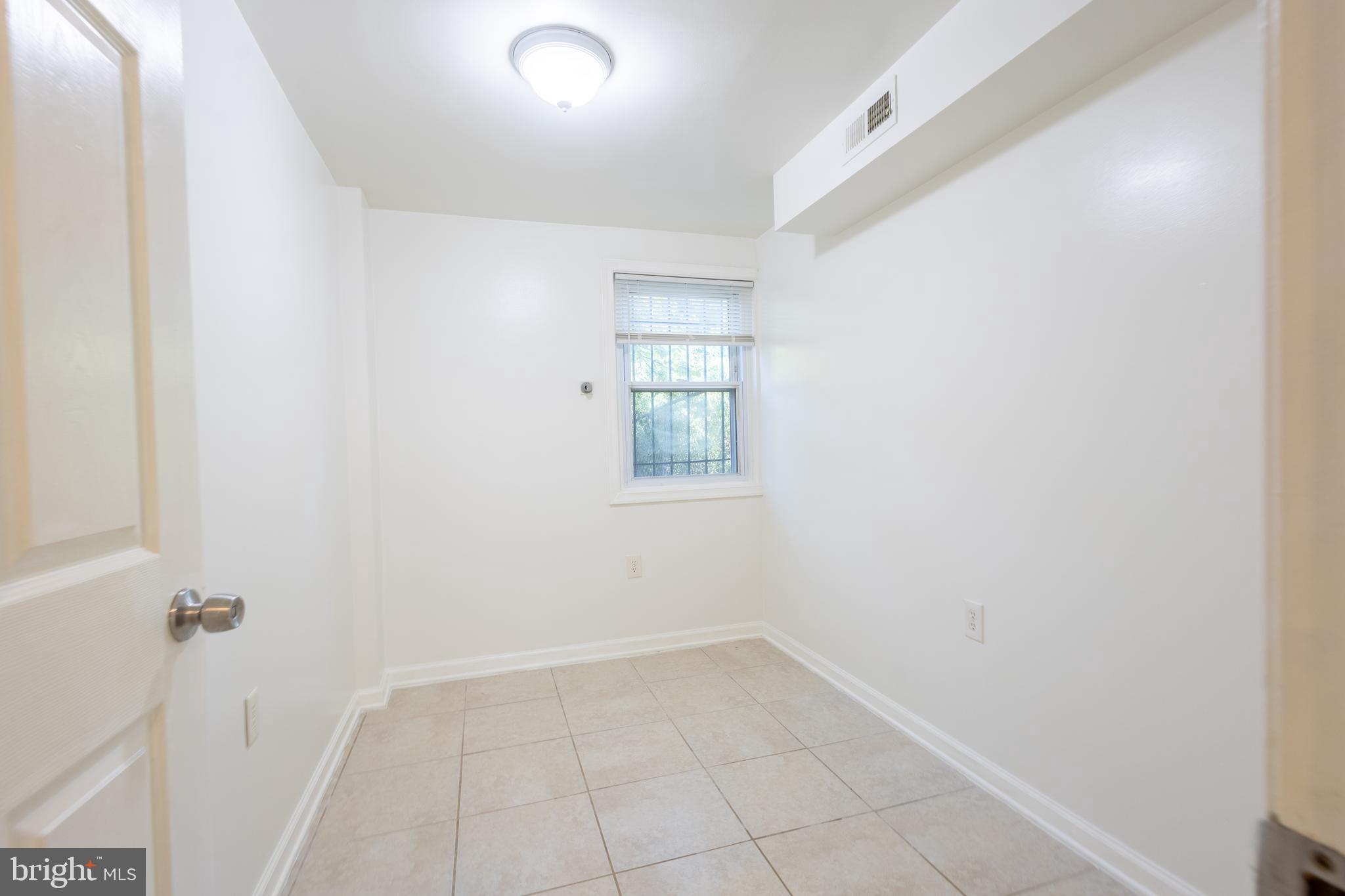 314 Atlantic Street Southeast, Unit 1 Washington, DC 20032 - Photo 5 of 17 an empty room with a window