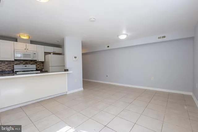 a kitchen with a refrigerator and a sink