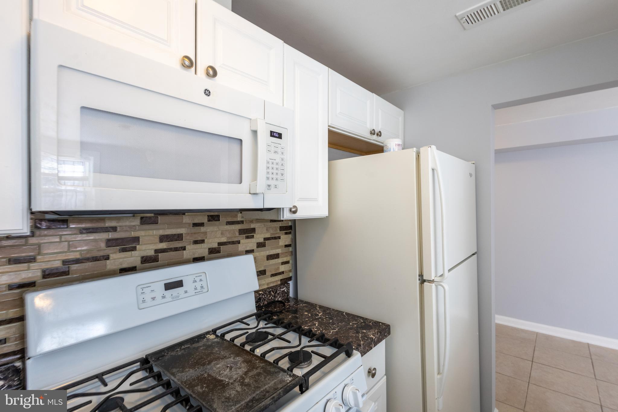 314 Atlantic Street Southeast, Unit 1 Washington, DC 20032 - Photo 10 of 17 a kitchen with a stove and a refrigerator