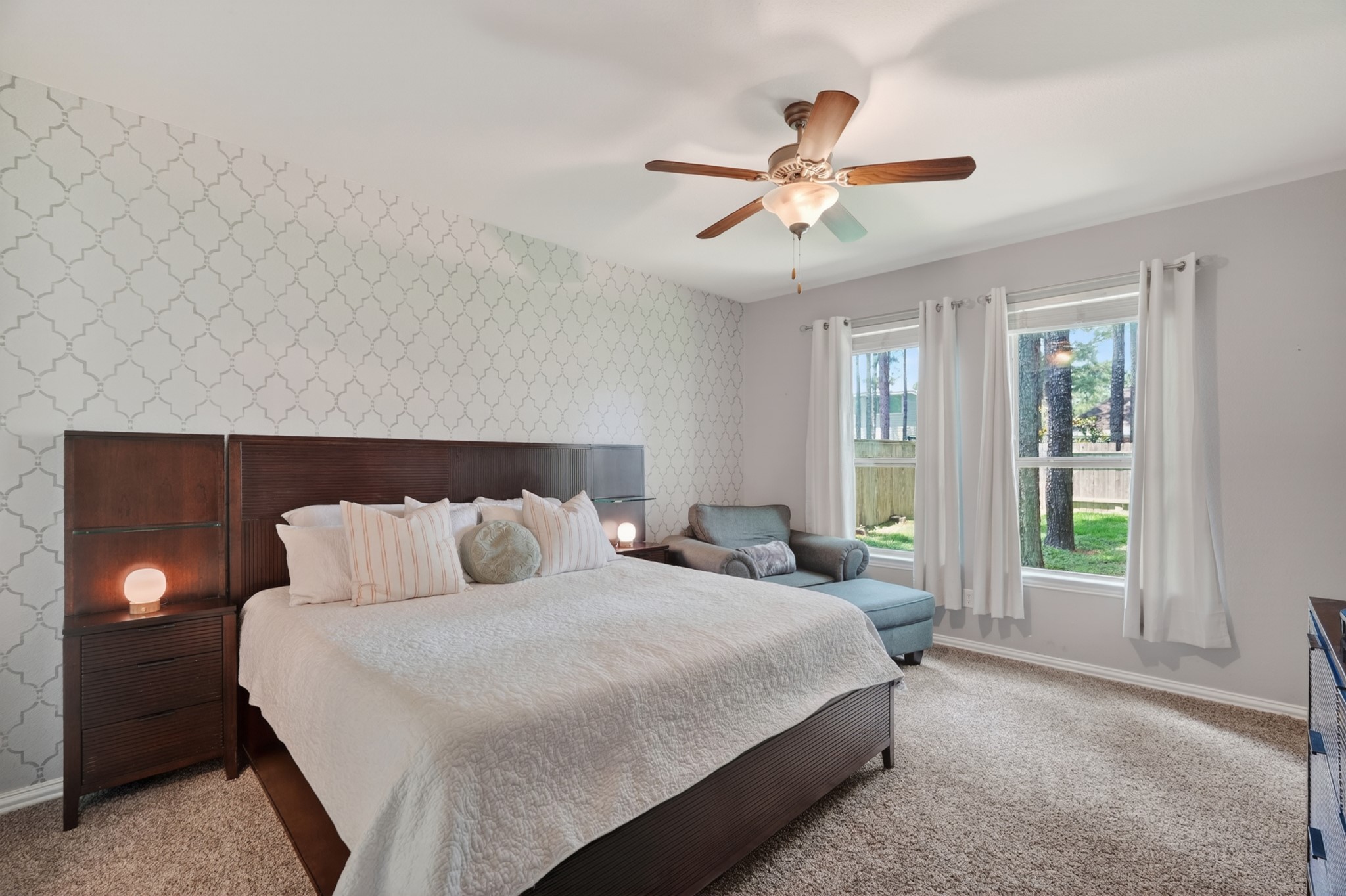 79 West Jagged Ridge Circle Spring, TX 77389 - Photo 22 of 50 The primary bedroom offers a generously sized retreat with plush carpet, a soft neutral palette, and large windows that fill the room with natural light. There's plenty of space for a king-size bed and additional furniture, creating a true at-home escape.
