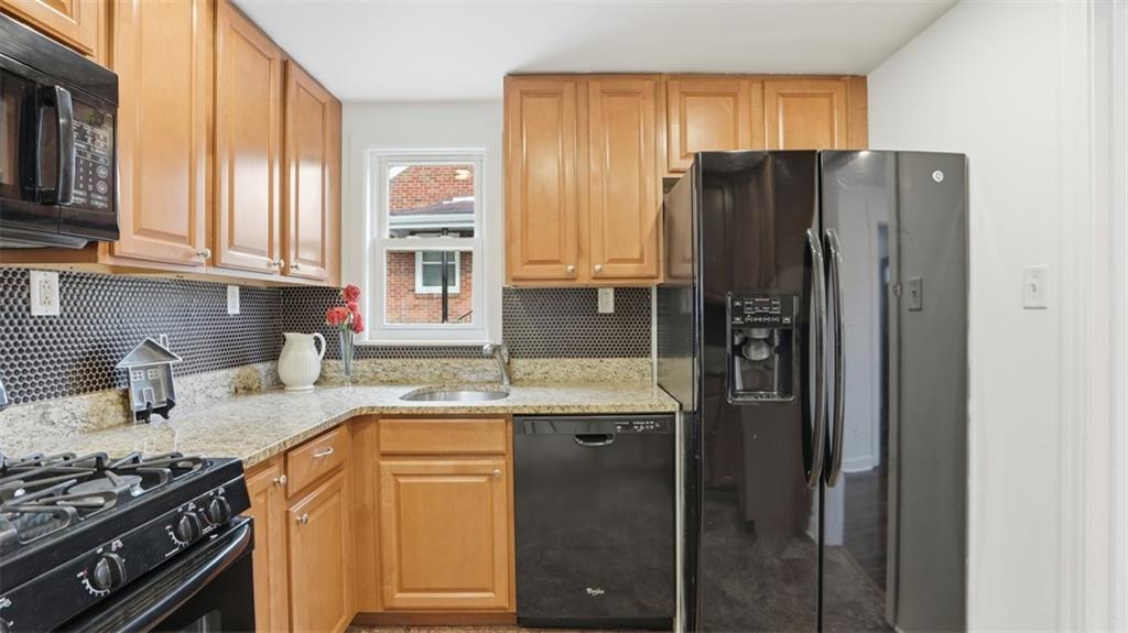 502 Weyman Road Pittsburgh, PA 15236 - Photo 12 of 39 a kitchen with stainless steel appliances granite countertop a refrigerator and a stove top oven