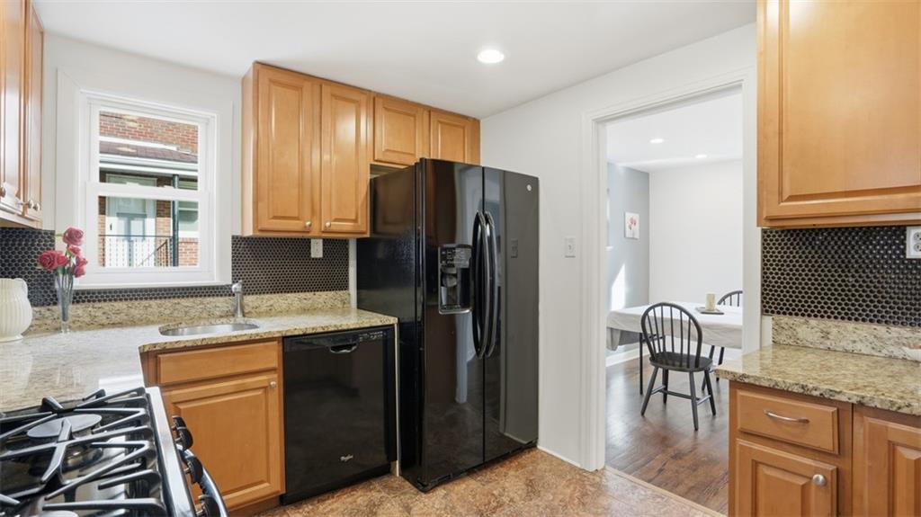 502 Weyman Road Pittsburgh, PA 15236 - Photo 13 of 39 a kitchen with granite countertop kitchen island stainless steel appliances a refrigerator a stove a sink a dining table and chair
