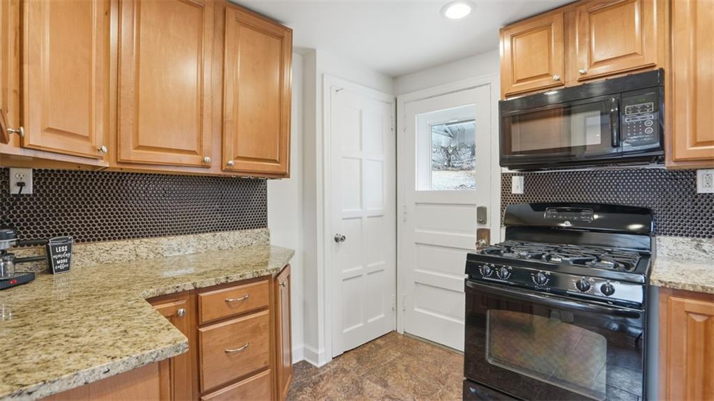 502 Weyman Road Pittsburgh, PA 15236 - Photo 14 of 39 a kitchen with granite countertop cabinets stainless steel appliances and a counter space