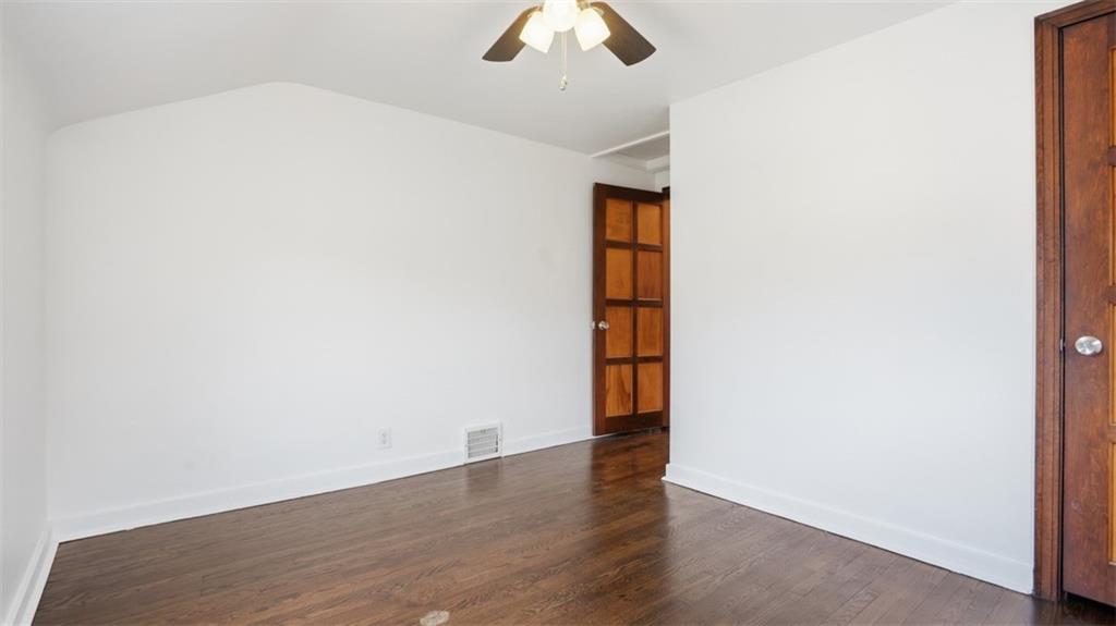 502 Weyman Road Pittsburgh, PA 15236 - Photo 25 of 39 an empty room with wooden floor chandelier fan and windows