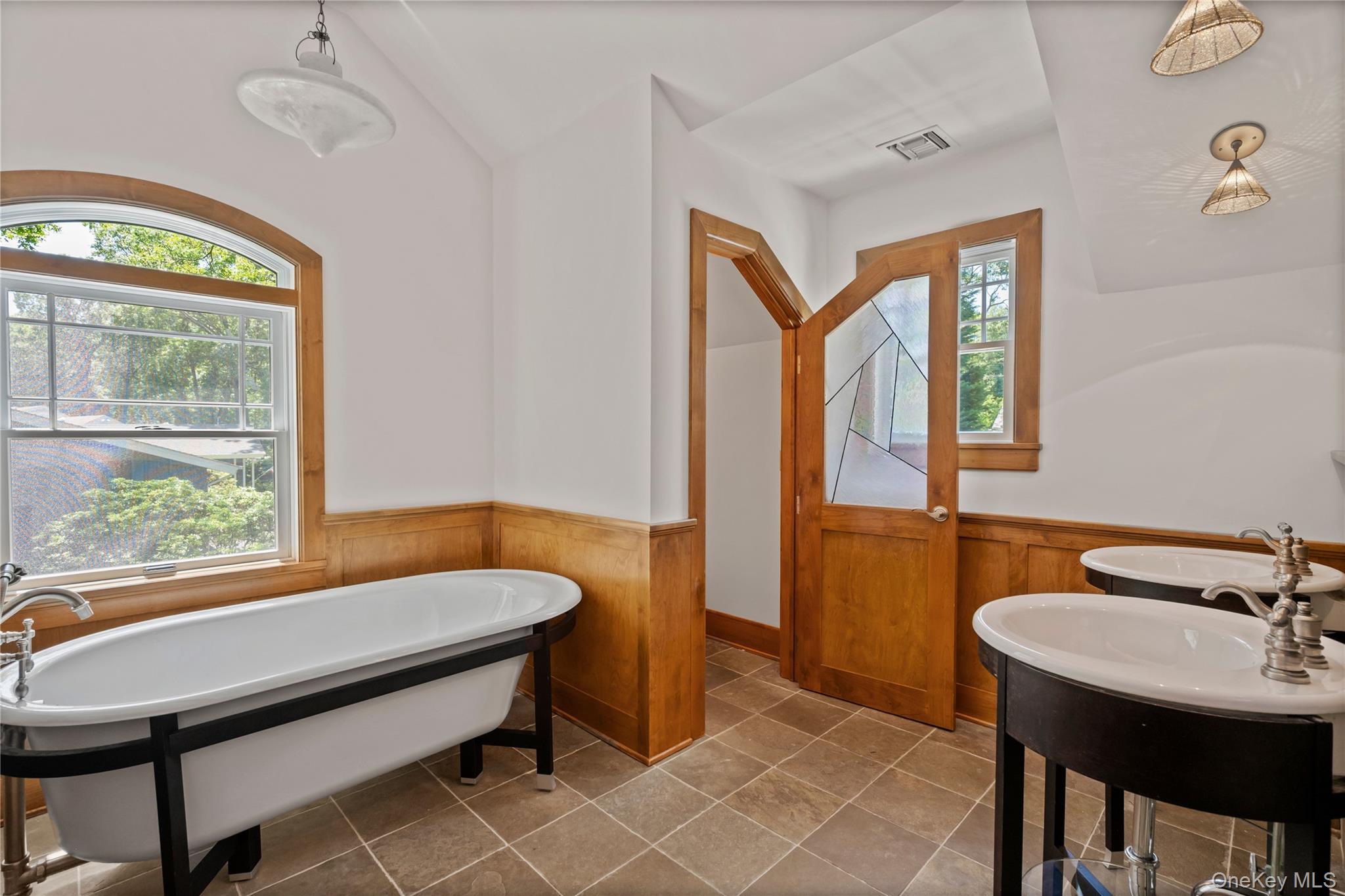 4745 North Bayview Road Southold, NY 11971 - Photo 15 of 31 Bathroom with a wainscoted wall, a freestanding tub, wooden walls, and vaulted ceiling