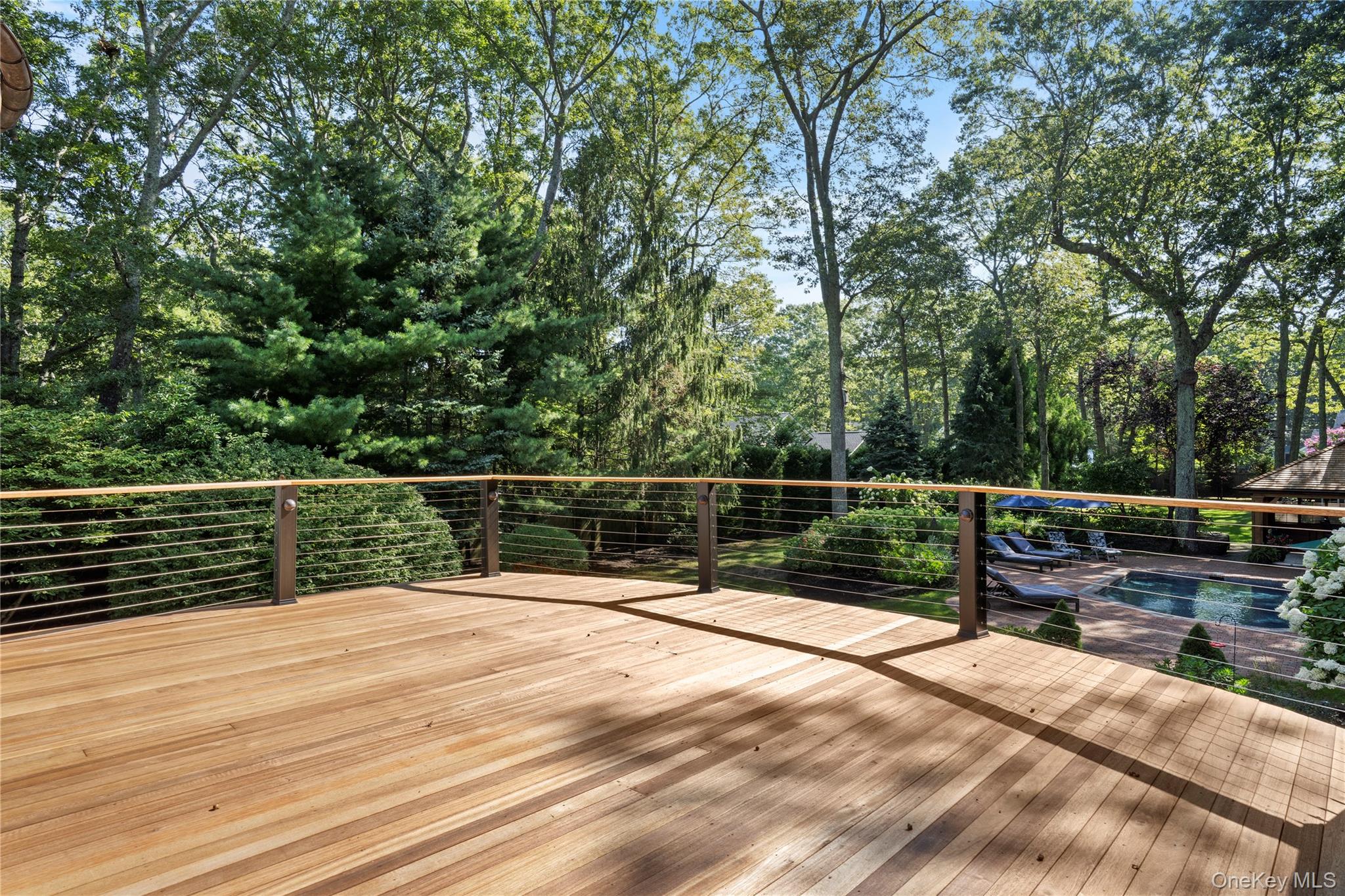 4745 North Bayview Road Southold, NY 11971 - Photo 18 of 31 Deck with an outdoor pool and view of scattered trees
