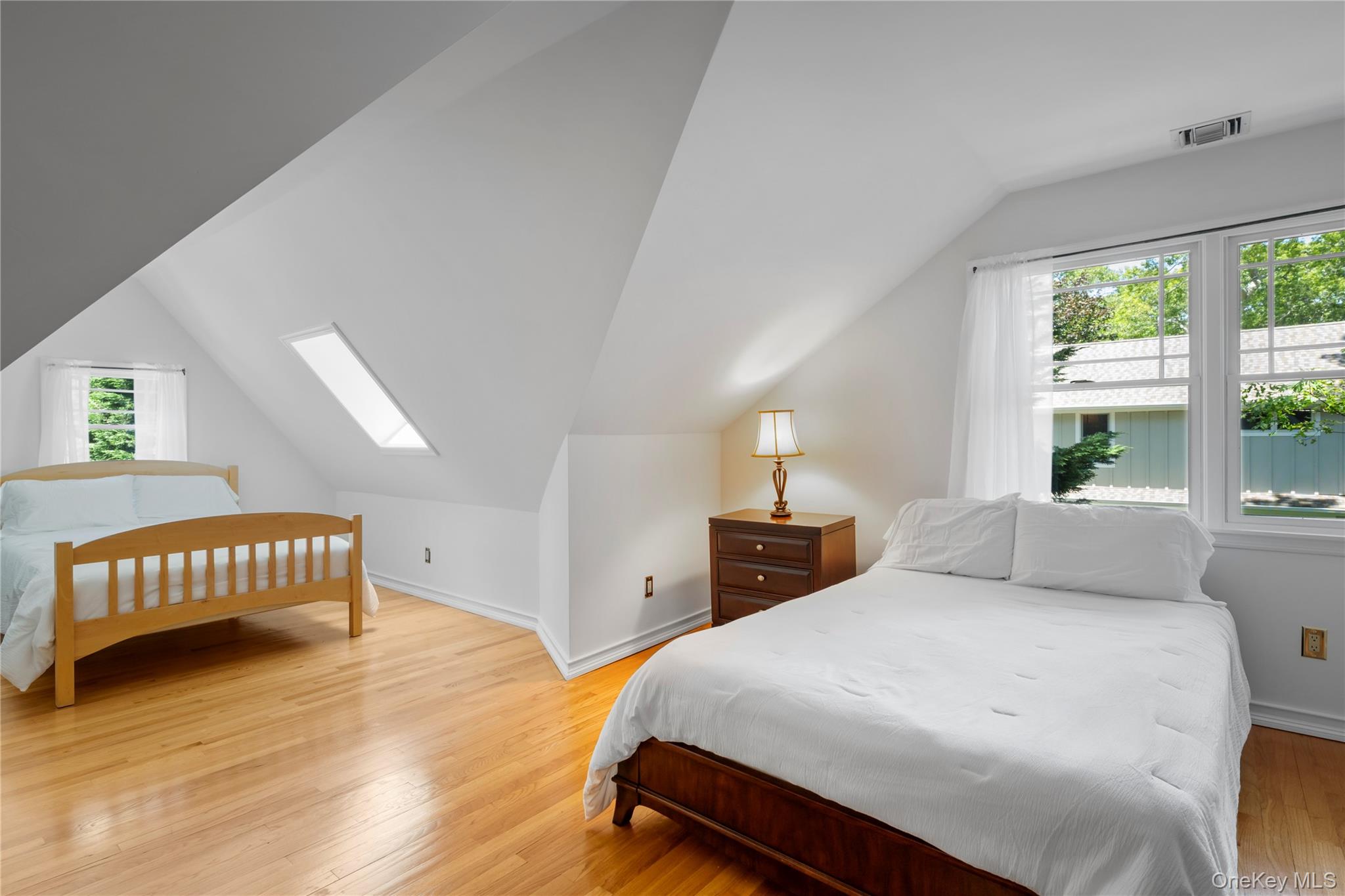 4745 North Bayview Road Southold, NY 11971 - Photo 20 of 31 Bedroom featuring vaulted ceiling, light wood-type flooring, and a skylight