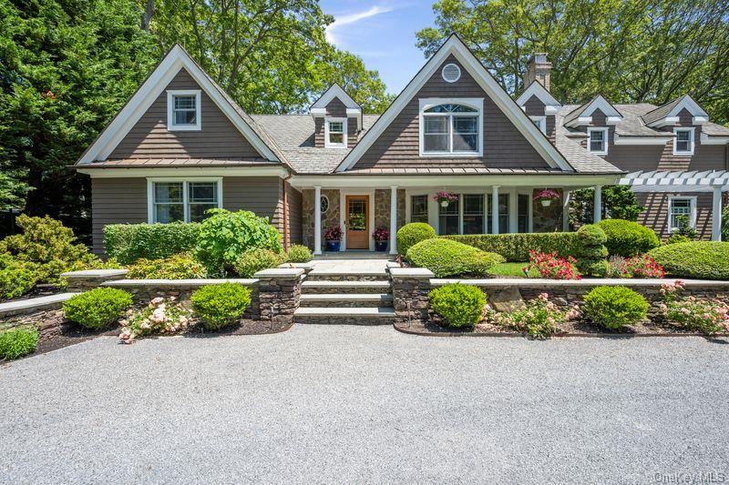 4745 North Bayview Road Southold, NY 11971 - Photo 2 of 31 Shingle-style home with a porch, a standing seam roof, and a metal roof