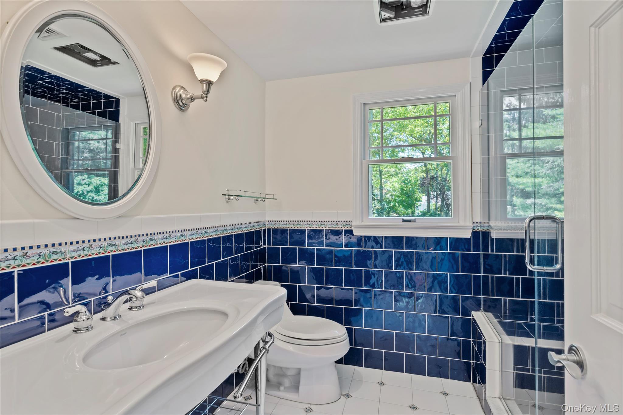 4745 North Bayview Road Southold, NY 11971 - Photo 21 of 31 Full bathroom featuring tile patterned flooring, tile walls, a wainscoted wall, and an enclosed shower