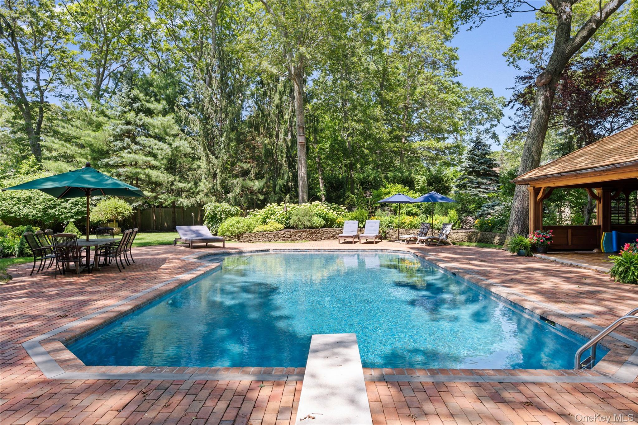 4745 North Bayview Road Southold, NY 11971 - Photo 23 of 31 View of pool featuring a patio, a gazebo, a diving board, and view of scattered trees