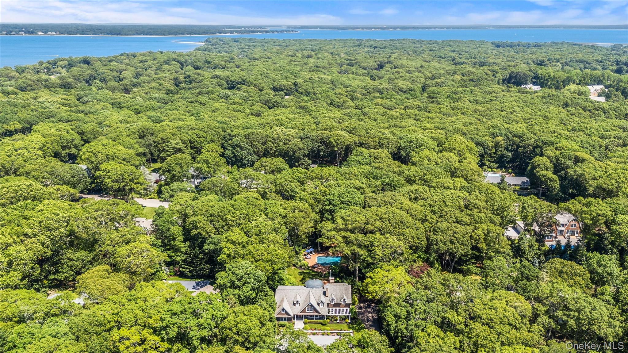 4745 North Bayview Road Southold, NY 11971 - Photo 28 of 31 Aerial view of a heavily wooded area and a large body of water